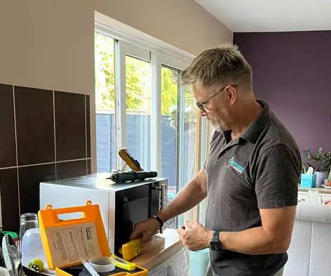 Colchester Domestic Repairs engineer carrying out a microwave safety leakage test